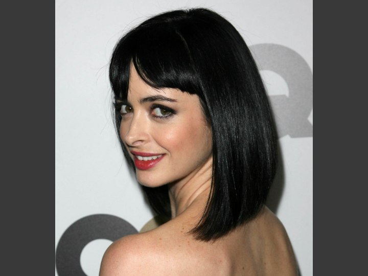 Krysten Ritter with hair that covers the neckline