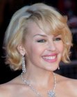 Kylie Minogue's short wavy bobbed hair with bangs across her forehead