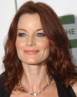 Laura Leighton's red hair styled with a zigzag part and lazy curls