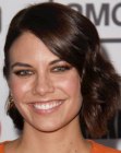 Lauren Cohan's neck length hairstyle with the hair on one side behind her ear
