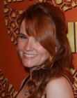 Redhead Lea Thompson with her curled hair worn over to one side