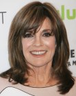 Linda Gray with layered hair that takes yearts off