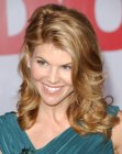 Lori Loughlin wearing her hair with a curve around one eye