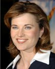 Lucy Lawless with her hair cut into a medium length style with layers