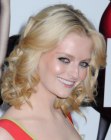 Lydia Hearst wearing a medium length hairstyle with the hair curled away from the face