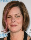 Marcia Gay Harden wearing her brown hair short and with a pink strand
