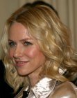 Naomi Watts wearing an easy mid-length hairstyle with a middle part