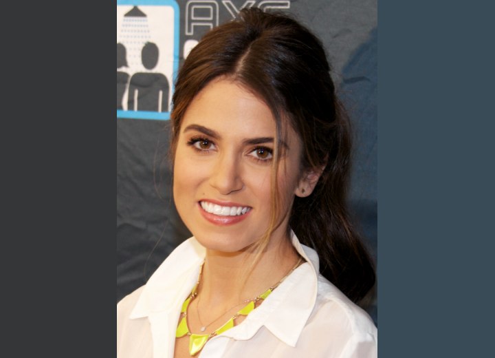 Nikki Reed's casual hairstyle with a long ponytail