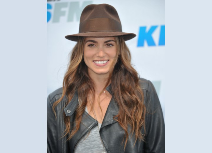 Nikki Reed wearing chest length hair and a hat