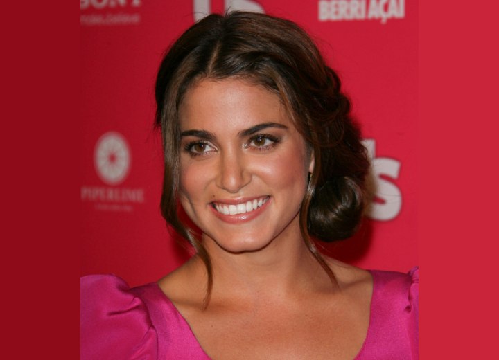 Nikki Reed wearing her hair in an updo with a plaited bun