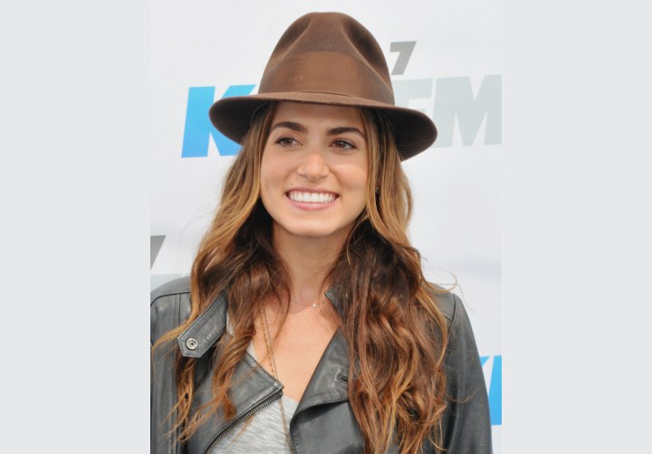 Nikki Reed wearing a sporty long hairstyle and hat