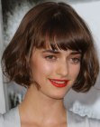 Olya Zueva's short bob with hair that curls up and under