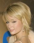 Paris Hilton with her hair cut in a semi-short style with razor cutting