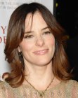 Parker Posey wearing her hair in a long shag with bangs