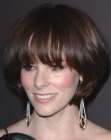 Parker Posey sporting a short hairstyle with long bangs