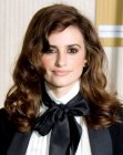 Penélope Cruz's feminine long hairstyle with curls and waves