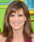Perrey Reeves wearing her brown hair in a long carefree style with bangs