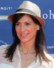 Perrey Reeves pairing simple long hair with a straw fedora hat