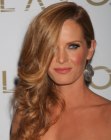Rebecca Mader with her curly hair styled over one shoulder