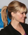 Reese Witherspoon sporting a young and fresh ponytail hairstyle with bangs