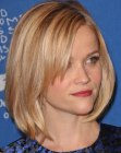 Reese Witherspoon with her hair cut in a smooth bob with long side bangs