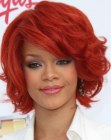 Rihanna's red hair cut into a neck-length style