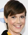 Zoe McLellan's wearing her hair short with a fringe and smooth styling