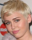 Miley Cyrus with her hair in a pixie cut with buzzed sides and back