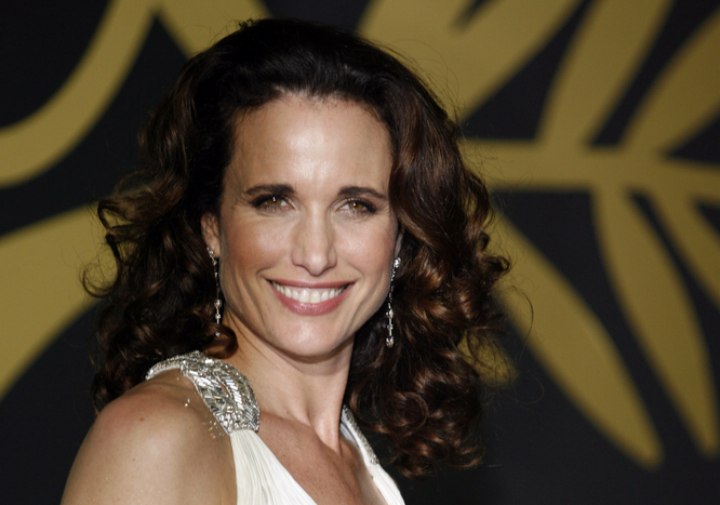 Andie MacDowell with her hair styled into spiral curls