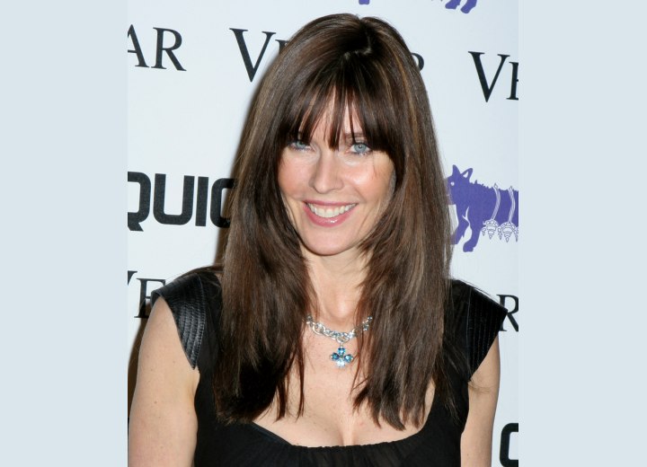 Carol Alt - Long textured hairstyle with below the eyebrows bangs
