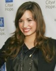 Demi Lovato sporting long hair with a free fall of curls