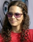 Halle Berry with long naturally curly hair that hangs below her shoulders