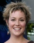 Kim Rhodes with her hair chopped short and styled for volume
