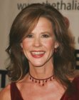 Linda Blair wearing her hair long and with large rolled curls