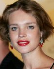 Natalia Vodianova with her wavy hair cut short and parted in the middle
