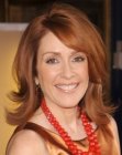 Patricia Heaton sporting shoulder length red hair with ends that flip up