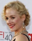 Penelope Ann Miller's curly short hair with an off centered part