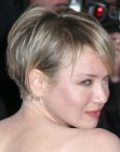 Renee Zelwegger with her hair cut short in a pixie with bangs