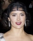Salma Hayek's retro look with her hair styled up with curls along the back