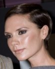 Victoria Beckham's short hairstyle with the sides tucked behind her ears