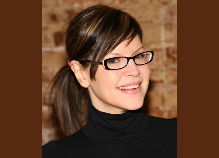 Lisa Loeb with glasses and wearing her hair in a ponytail