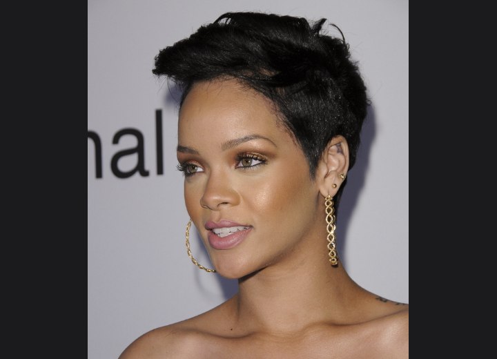 Photo of Rihanna with very short hair. Rihanna's coal back hair condenses 