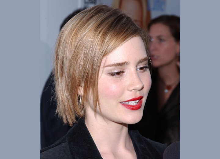 Hair cut in a side-parted bob with a slightly choppy look for Alison Lohman