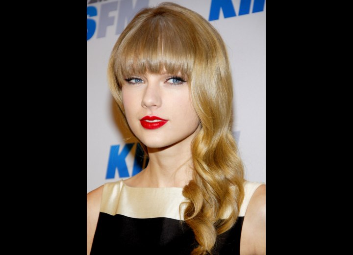 Taylor Swift wearing her hair long with full bangs