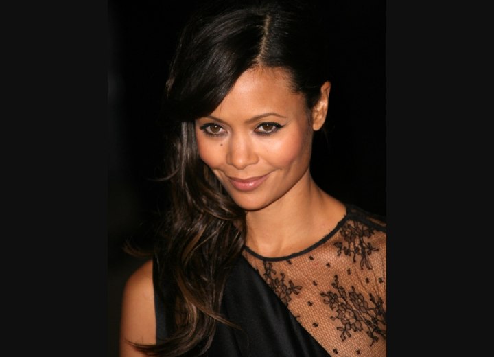 Thandie Newton wearing her hair styled in front of one shoulder