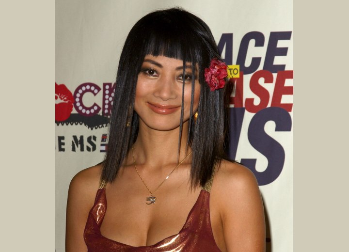 Bai Ling wearing a flower in her straight black hair