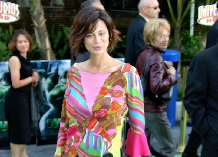 Catherine Bell wearing a colorful tunic blouse