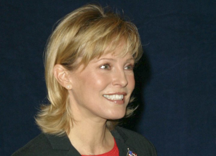 Side view of Cheryl Ladd's layered haircut with thinned out bangs