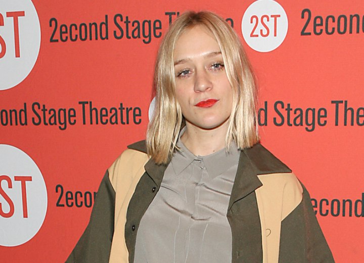 Chloë Sevigny wearing a silk shirt with the collar buttoned-up