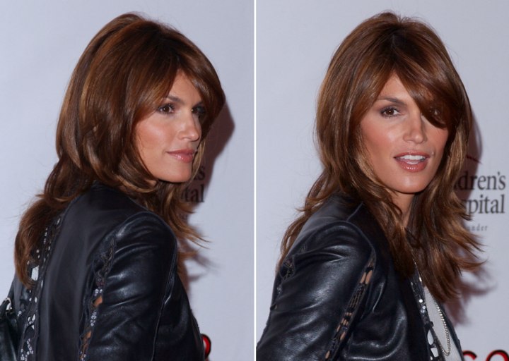 Back and side view of Cindy Crawford's long layered hairstyle